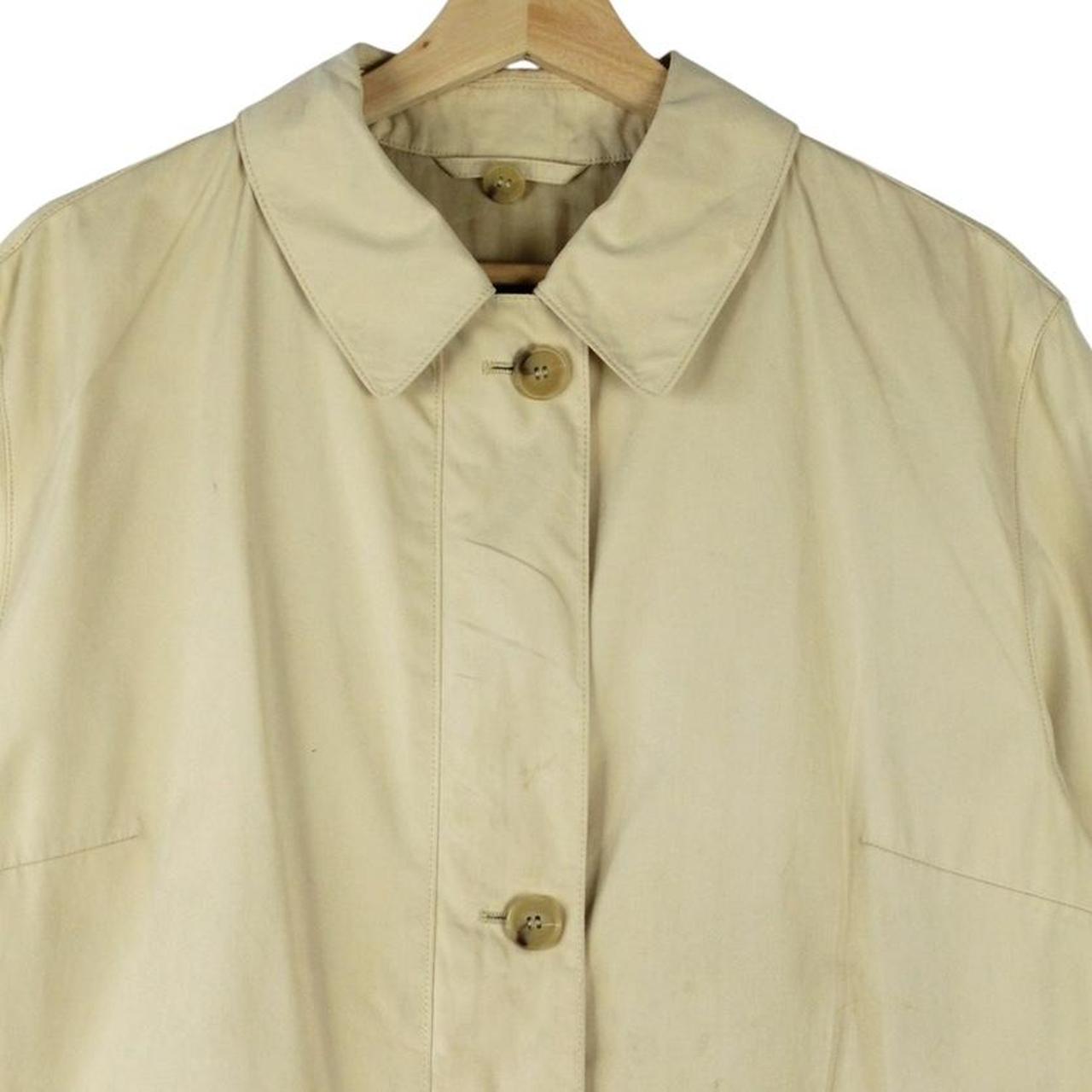 Burberry beige single breasted coat with logo detail and classic tailored design.