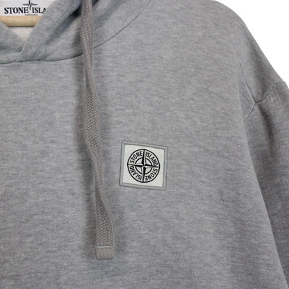 Stone Island grey cotton hoodie with logo patch and slight discolouration on sleeve.