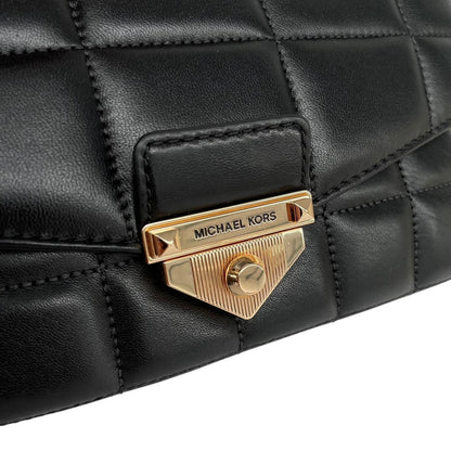 Michael Kors black duffel bag with quilted pattern and logo detail, pre-loved condition.