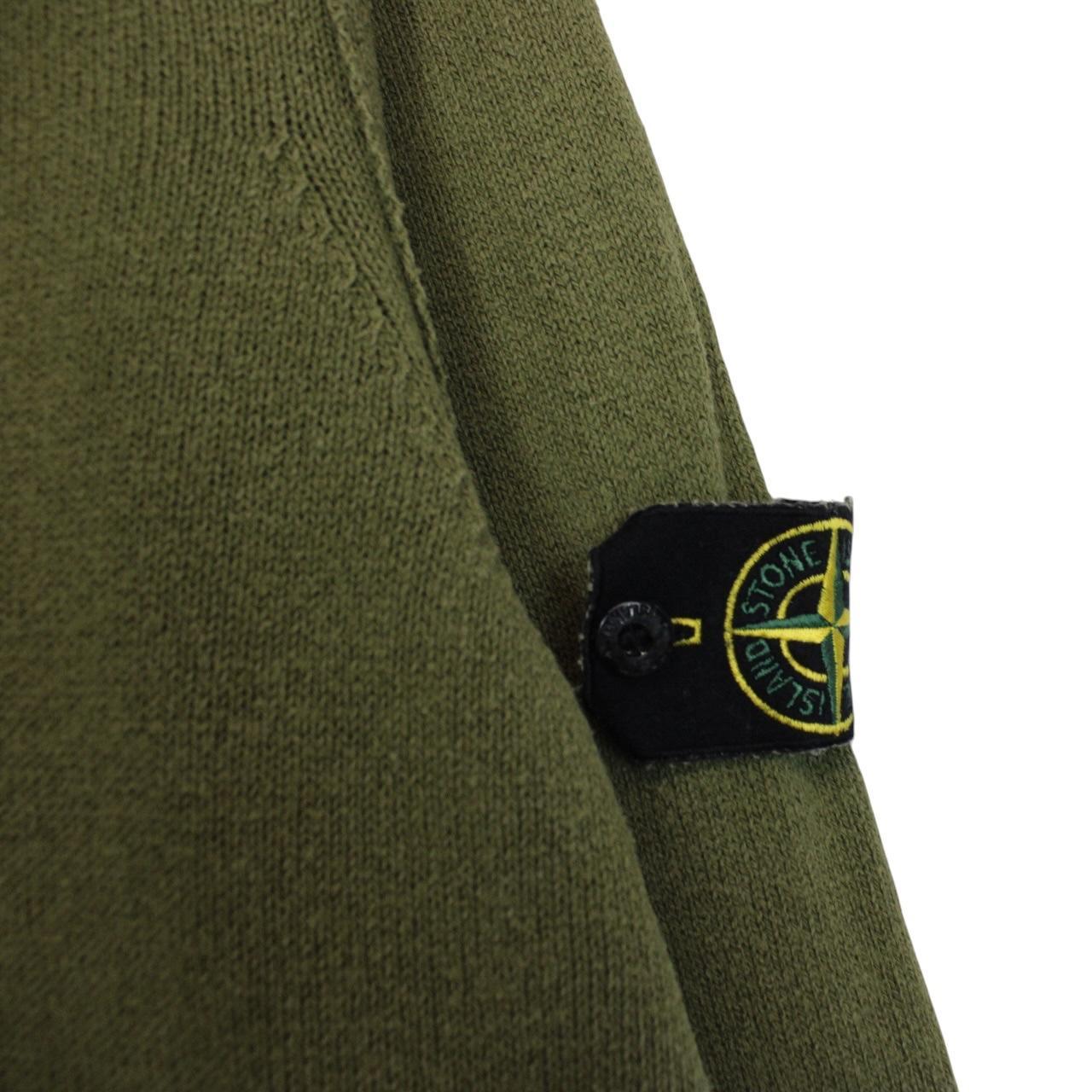 Stone Island green v-neck cotton knit jumper with logo patch and visible wear.