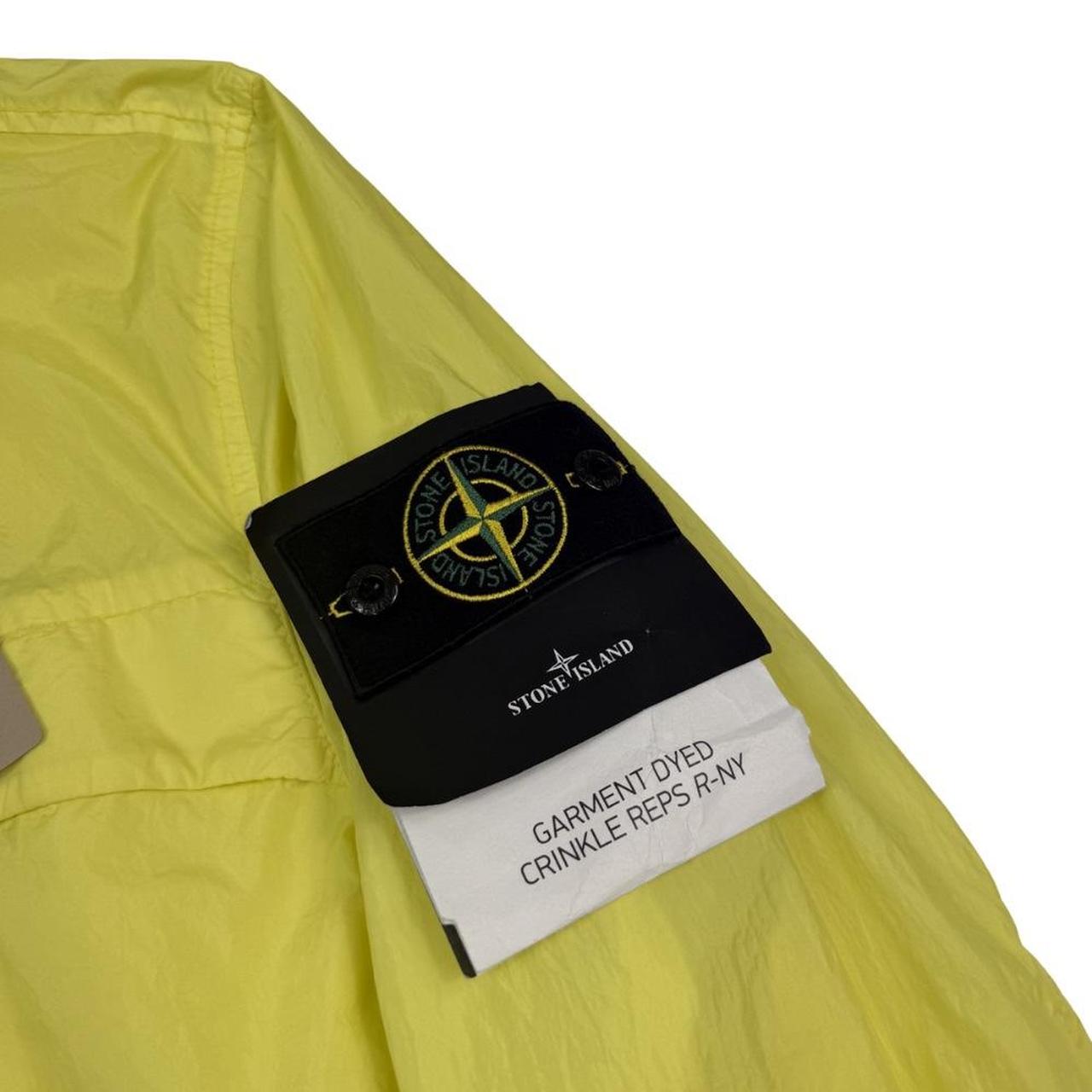 Stone Island yellow full zip jacket with crinkle texture and iconic compass logo.