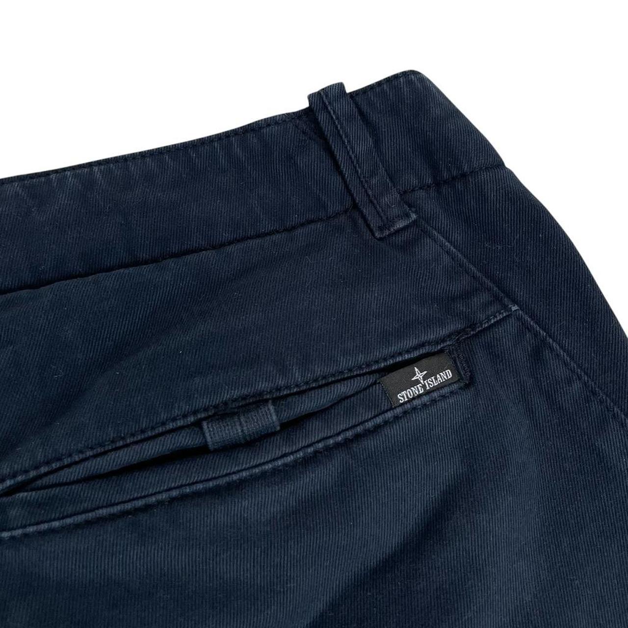 Stone Island navy blue skinny fit cotton trousers with logo patch and subtle wear.