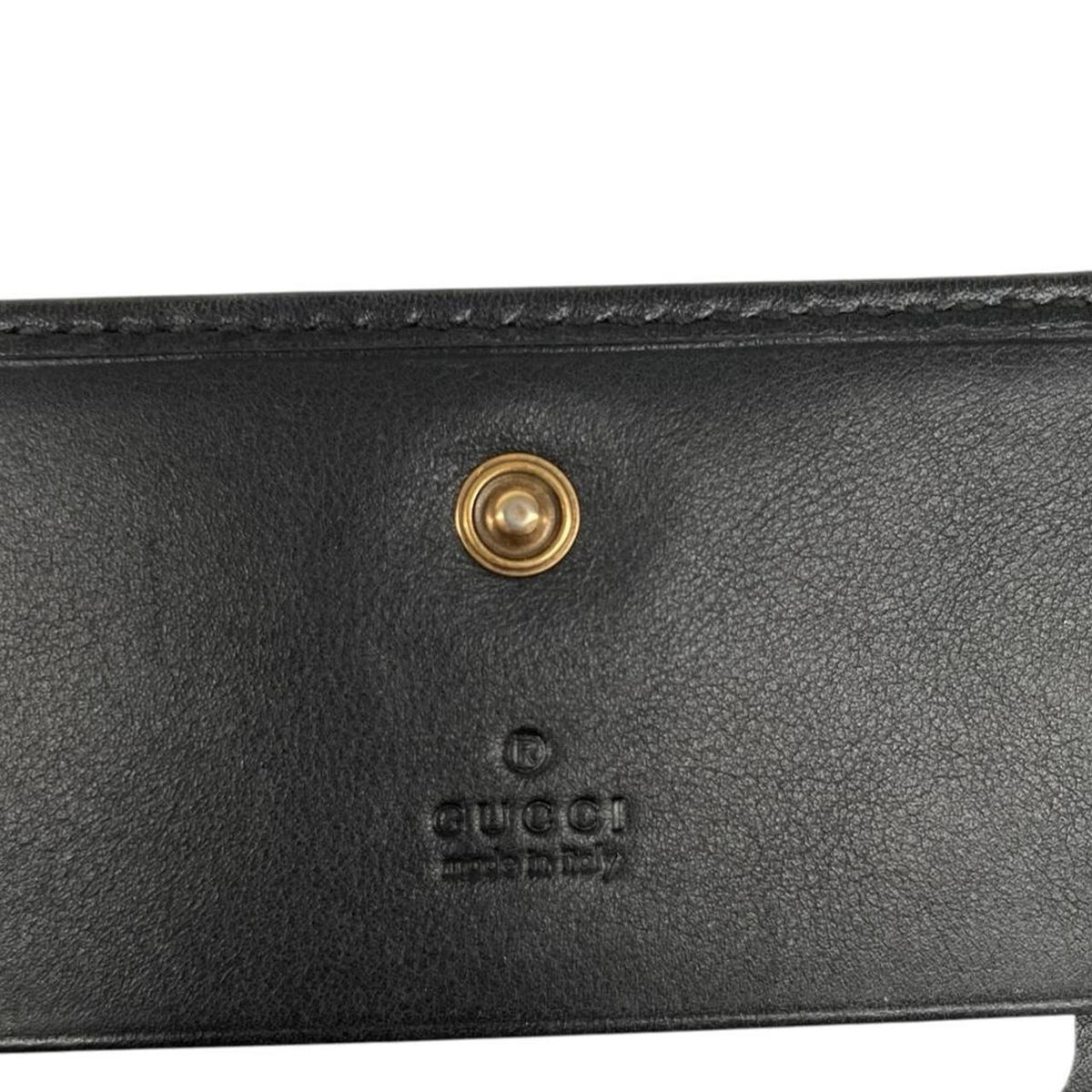 Gucci black calfskin wallet with matelassé pattern and GG logo detail.