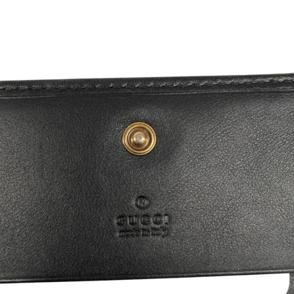 Gucci black calfskin wallet with matelassé pattern and GG logo detail.