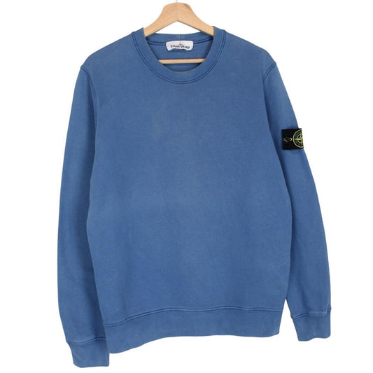 Stone Island blue cotton sweatshirt with logo patch and faded details.
