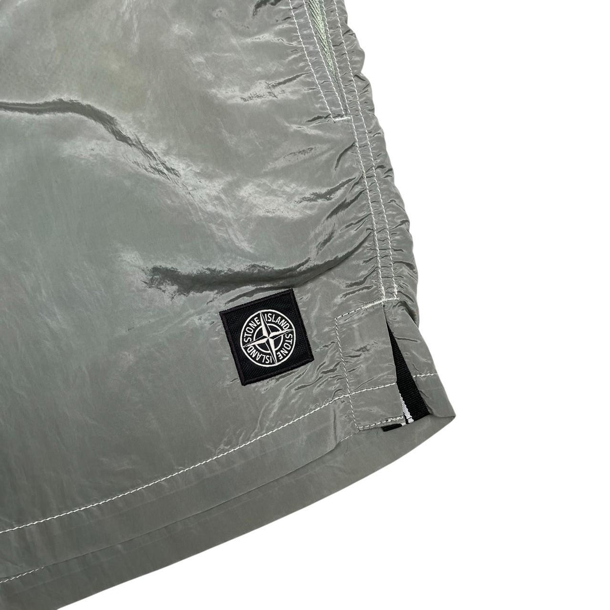 Stone Island green swim shorts with logo patch and nylon metal material.