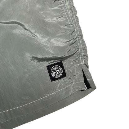 Stone Island green swim shorts with logo patch and nylon metal material.