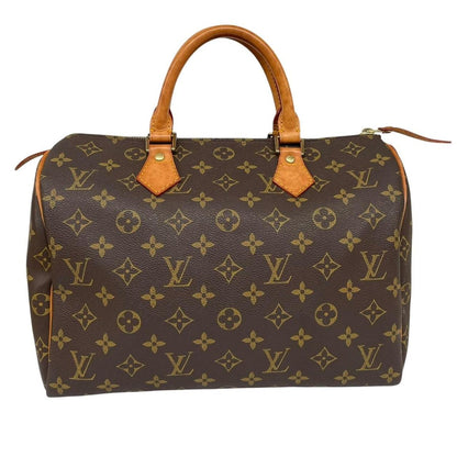 Louis Vuitton duffel bag beige and brown monogram coated canvas with leather trim.