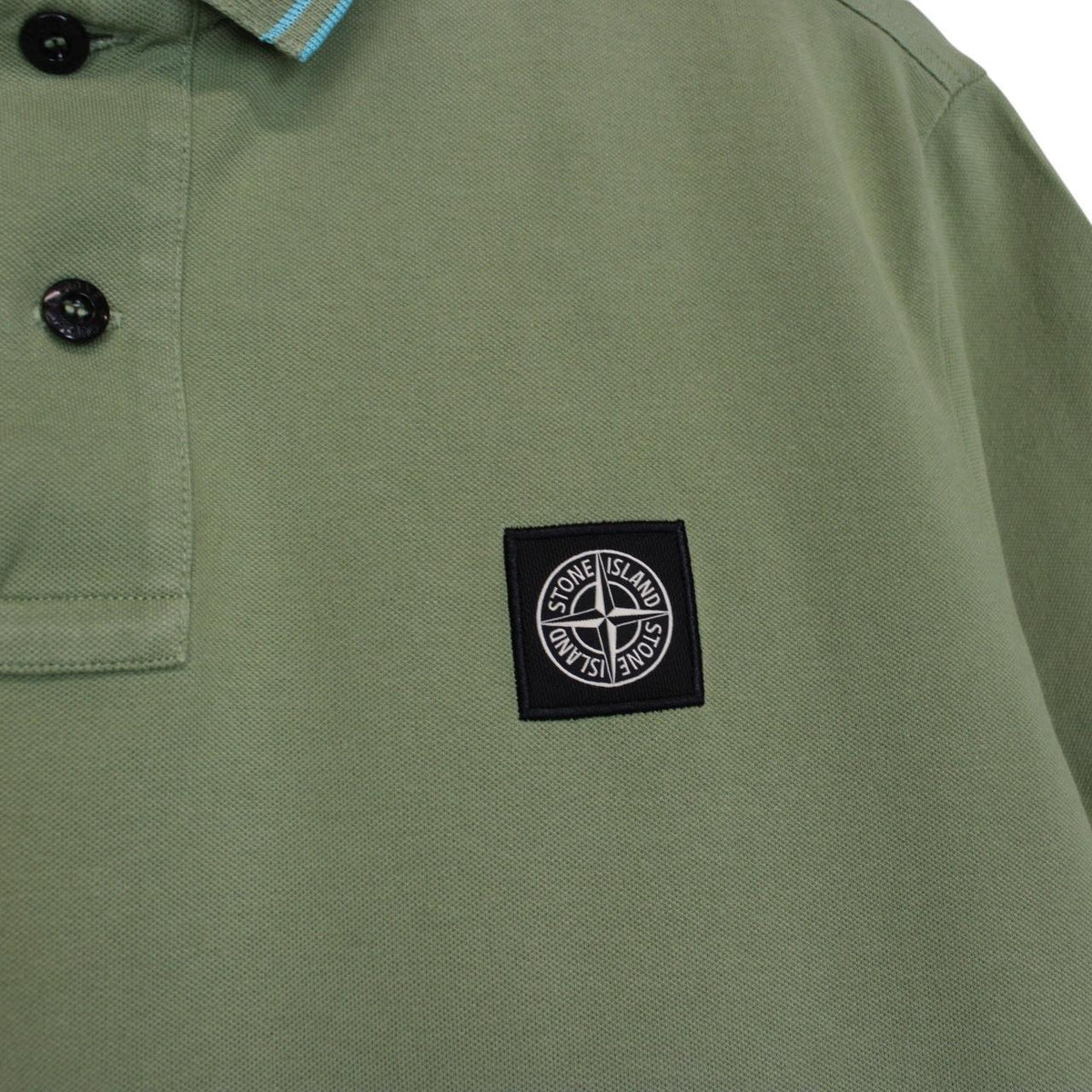 Stone Island green polo shirt with embroidered compass logo and cotton material.