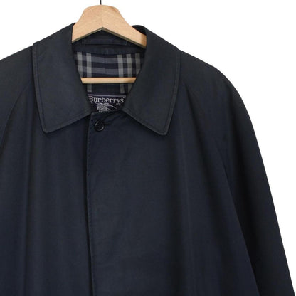 Burberry navy blue trench coat featuring classic Nova Check pattern and single-breasted design.