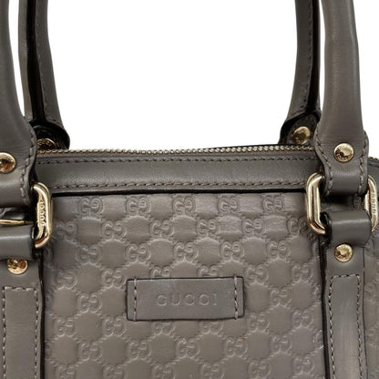 Gucci grey microguccissima mini dome shoulder bag with embossed logo and leather material.