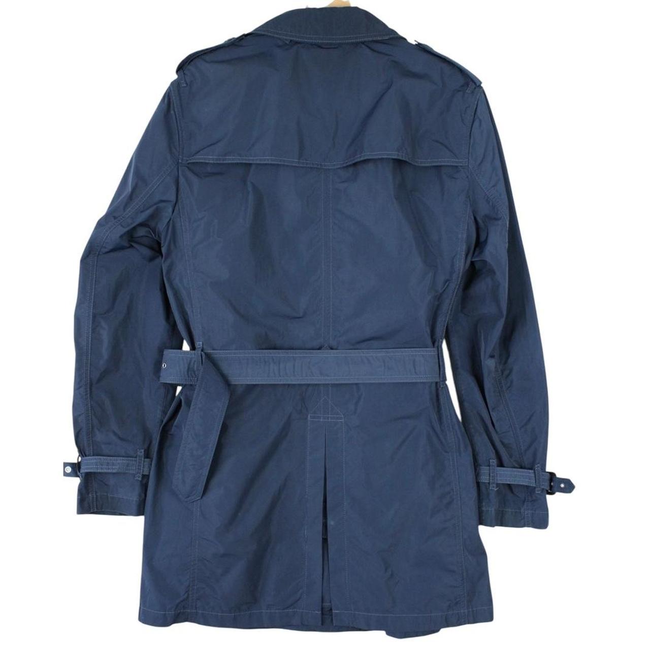 Burberry blue trench coat with Nova Check lining and belted double-breasted design.