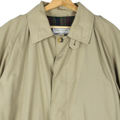 Yves Saint Laurent beige trench coat with single breasted design and belted waist.