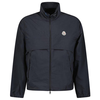 Moncler black windbreaker jacket with full zip, logo patch on sleeve, lightweight material.