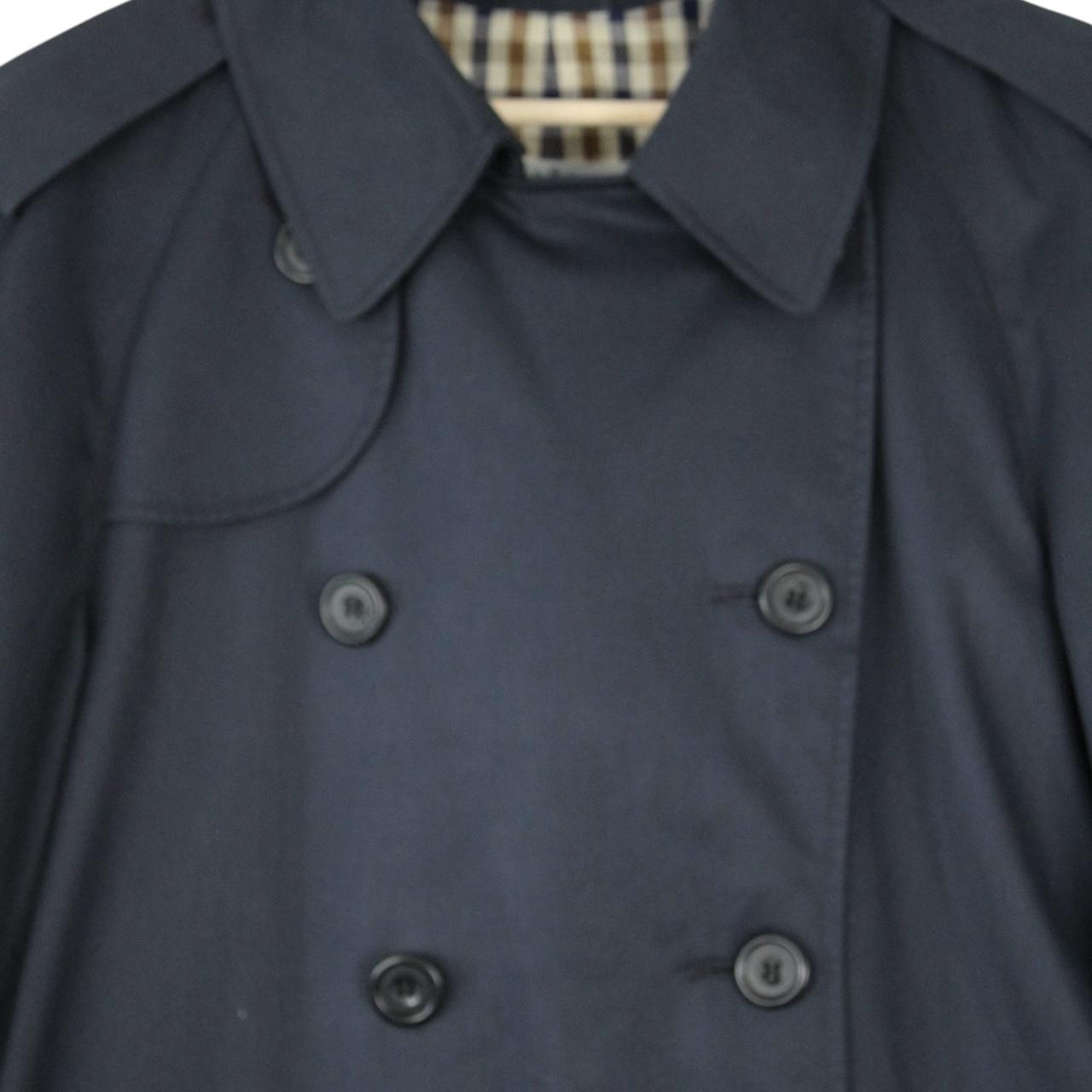 Aquascutum navy blue double breasted trench coat with house check pattern and logo.
