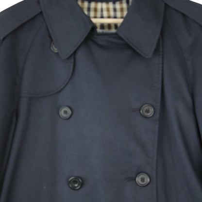 Aquascutum navy blue double breasted trench coat with house check pattern and logo.