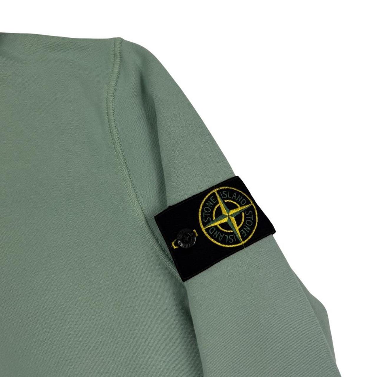 Stone Island green cotton hoodie with logo patch and drawstring hood.