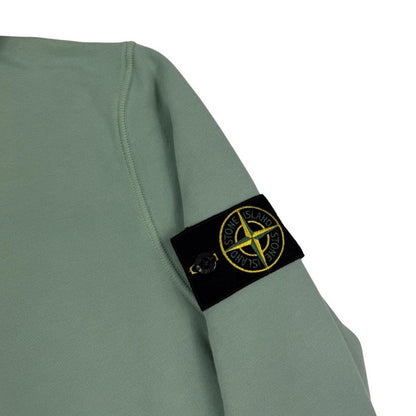 Stone Island green cotton hoodie with logo patch and drawstring hood.
