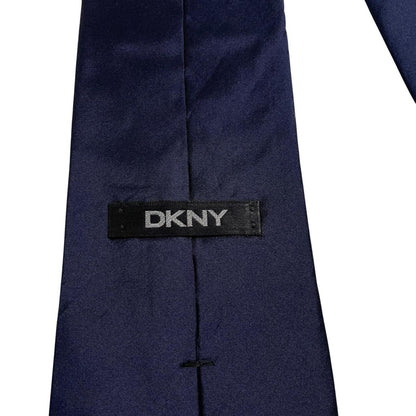 DKNY navy blue silk tie with subtle sheen and classic design.