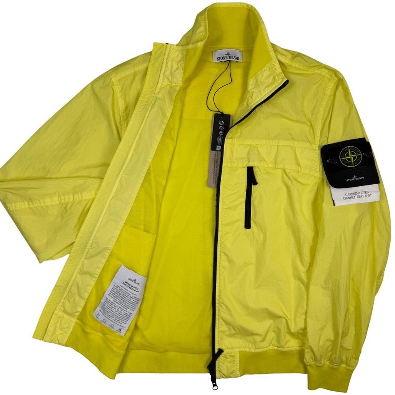 Stone Island yellow full zip jacket with crinkle texture and iconic compass logo.