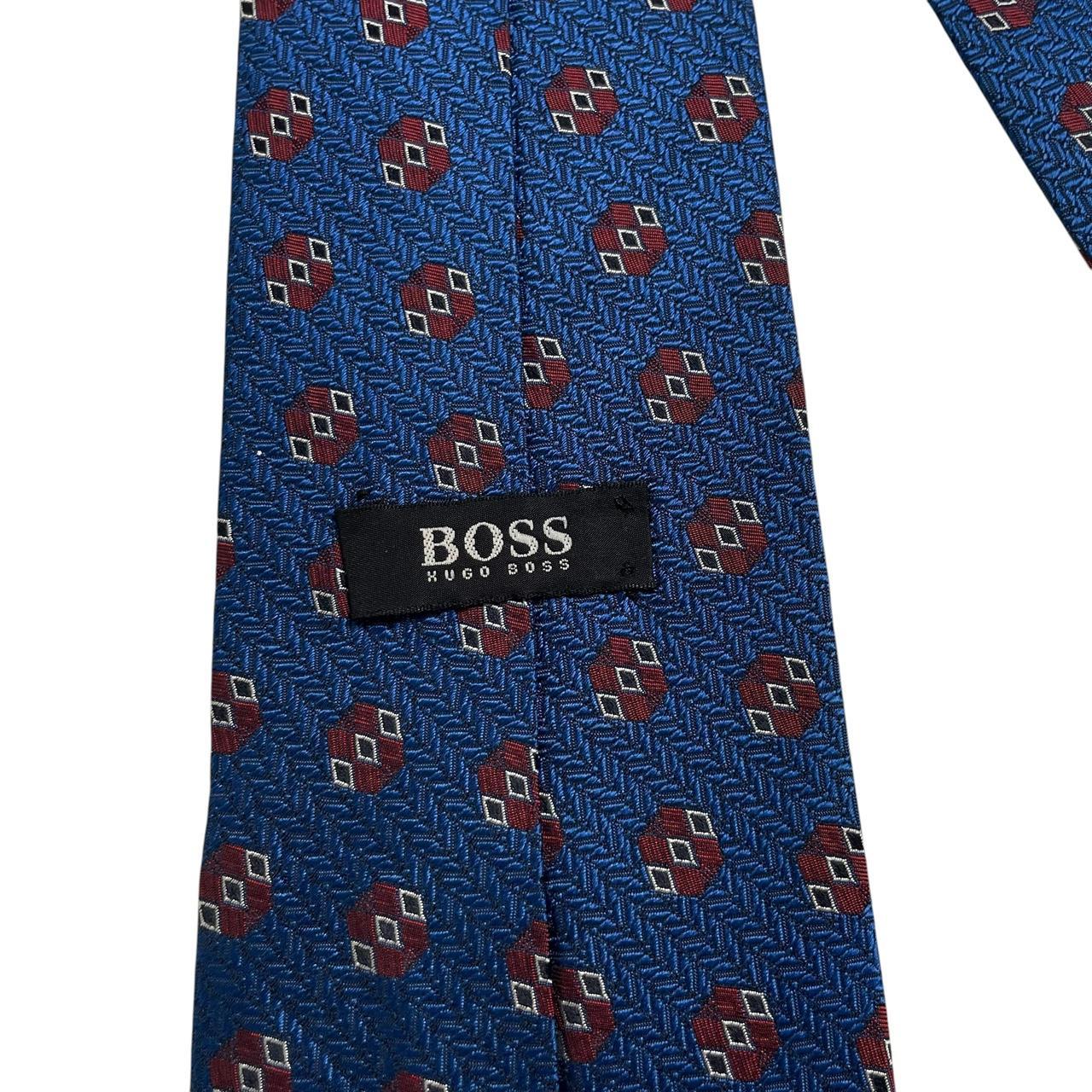 Hugo Boss blue silk tie with smooth texture and subtle sheen.