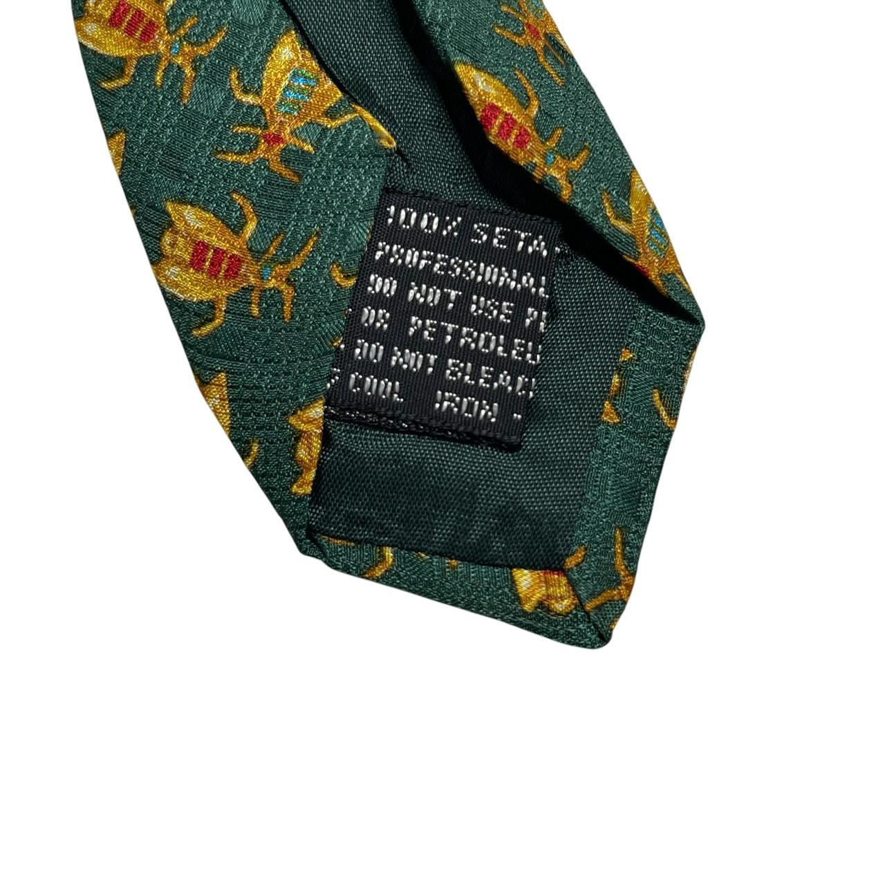 Versace silk tie green and gold baroque print with intricate design details.