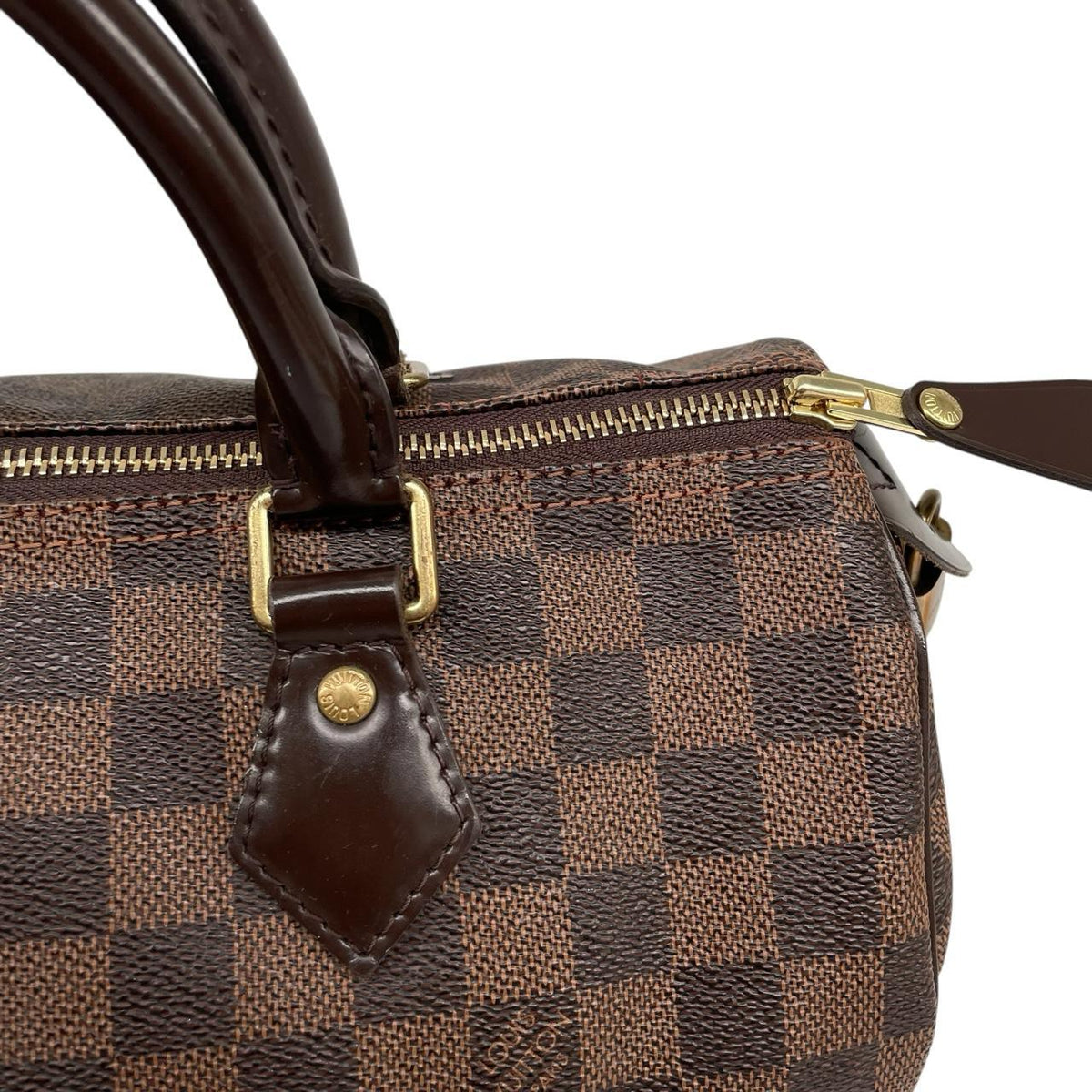 Louis Vuitton brown Damier Ebene canvas handbag with gold hardware and padlock detail.