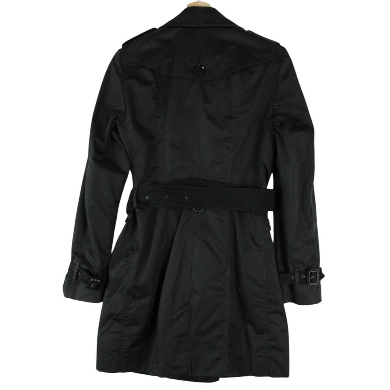 Burberry black double breasted belted trench coat with logo detailing and classic design.