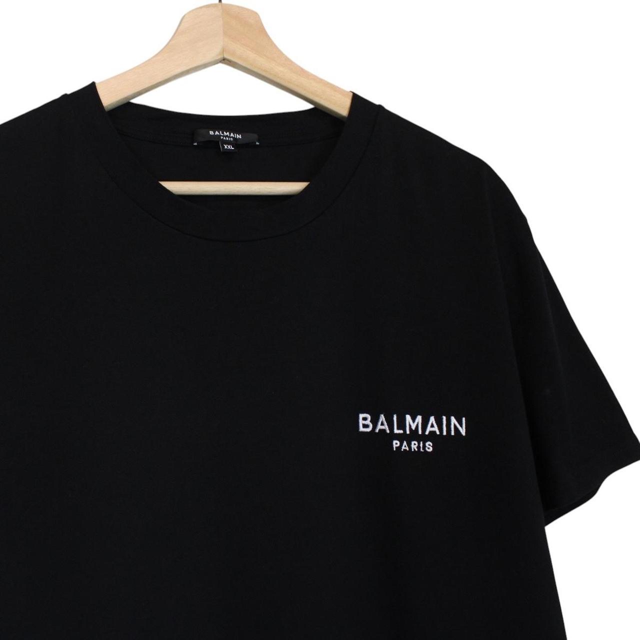 Balmain black pocket t-shirt with white embroidered logo and short sleeves.