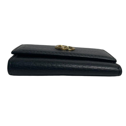 Gucci black leather key case with GG logo and quilted pattern.