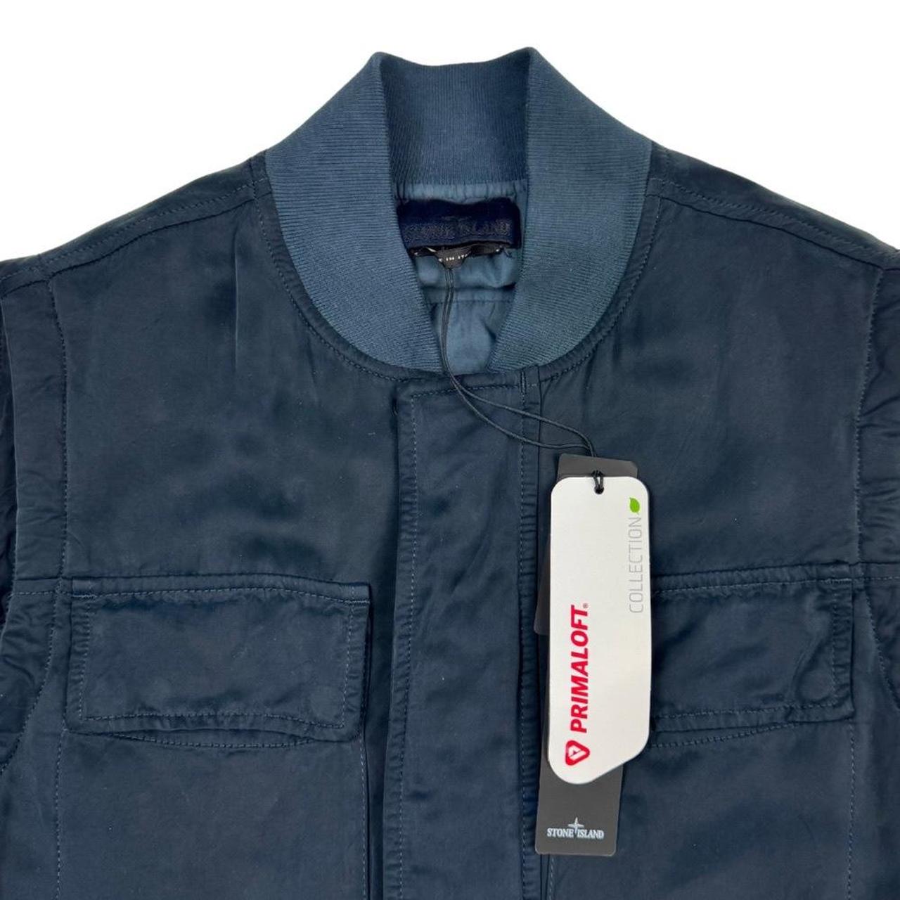 Stone Island navy blue vest jacket with logo patch and Primaloft material.