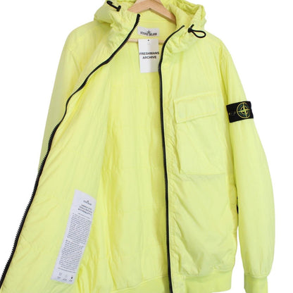 Stone Island yellow jacket with crinkle texture and logo badge on sleeve.