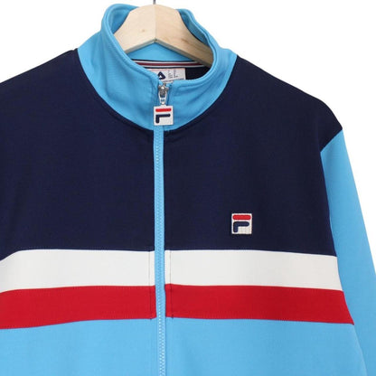 Fila blue track jacket with white stripes and embroidered logo on chest.