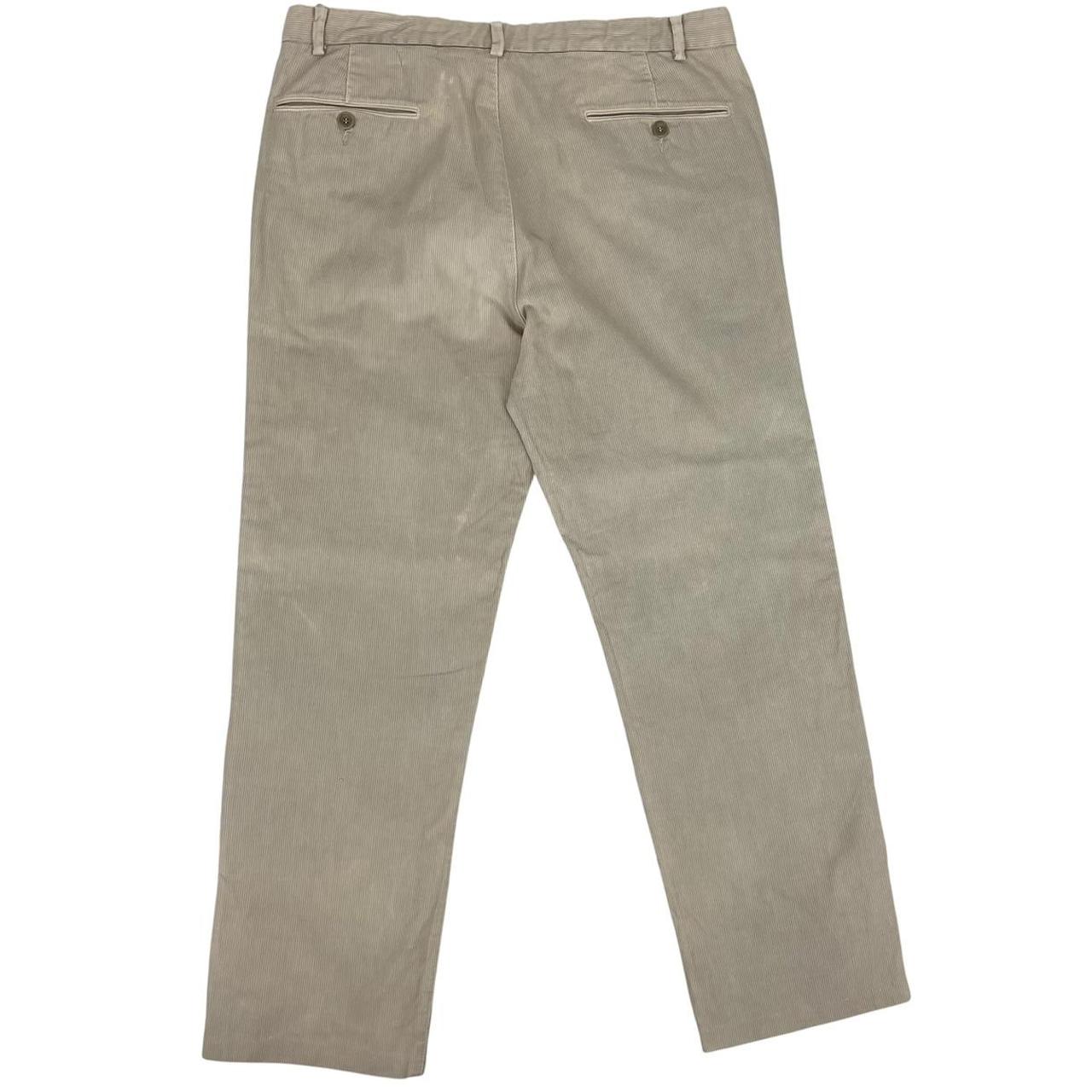CP Company beige ribbed cotton trousers with faint stains and regular fit design.
