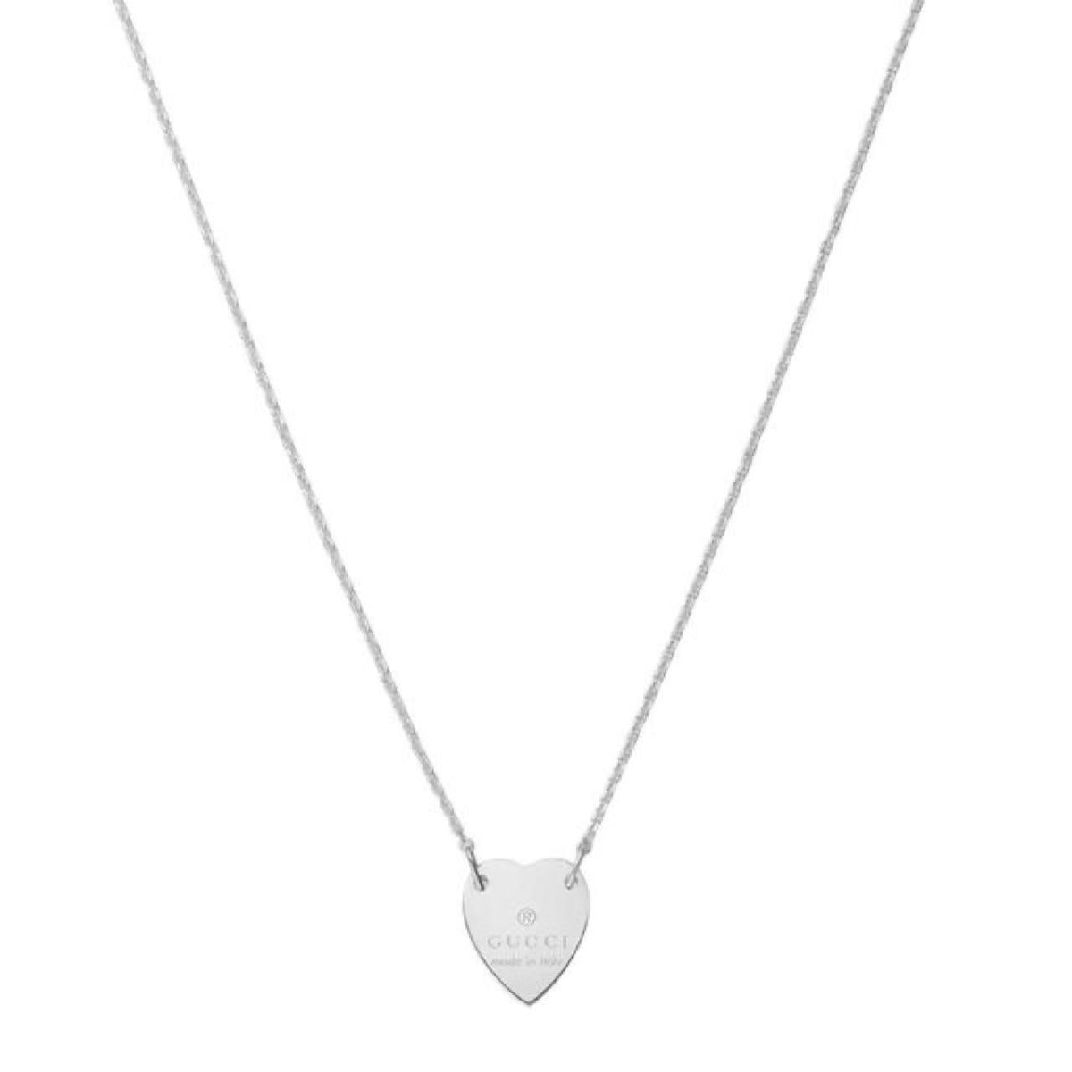 Gucci silver necklace with trademark heart pendant and minor scratches.