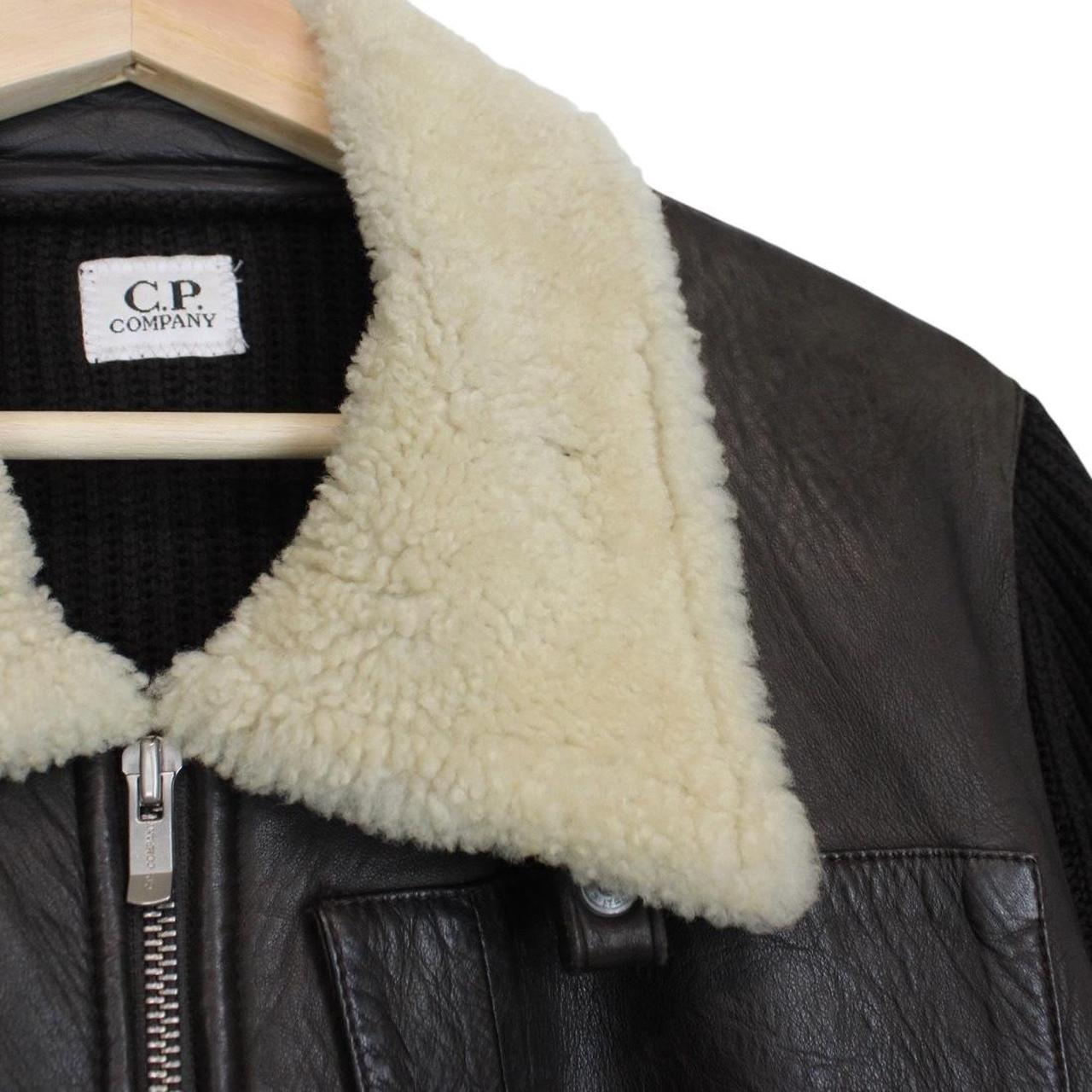 CP Company brown leather and wool shearling jacket with vintage design and logo details.