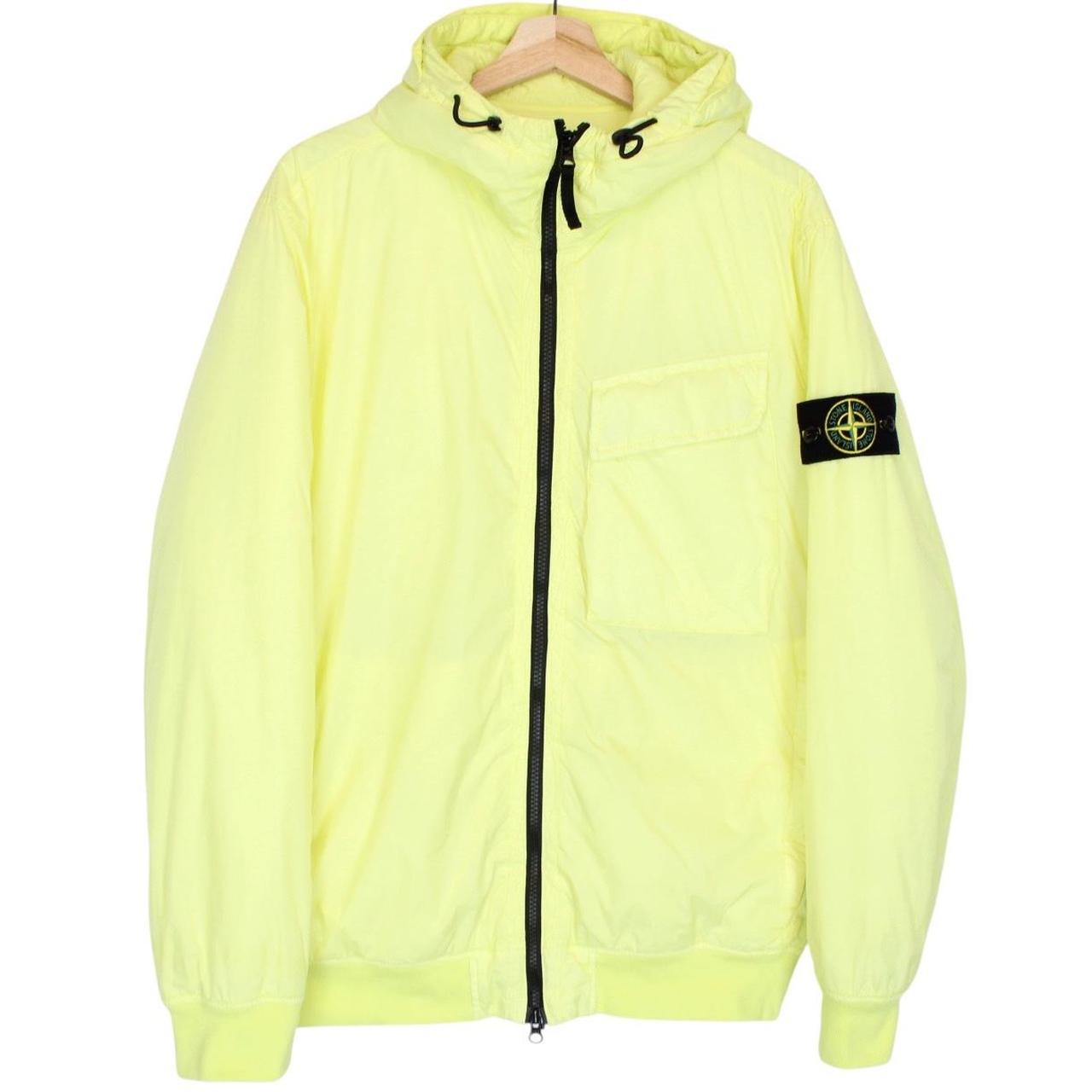 Stone Island yellow jacket with crinkle texture and logo badge on sleeve.