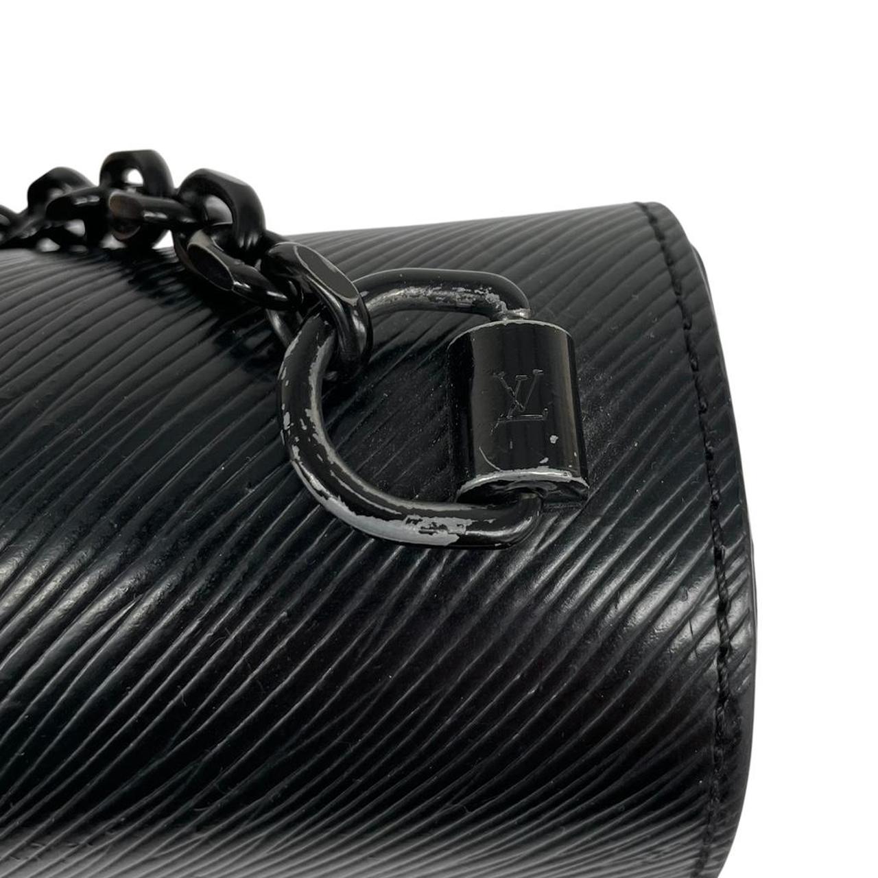 Louis Vuitton black Epi leather duffel bag with twist lock and visible wear.