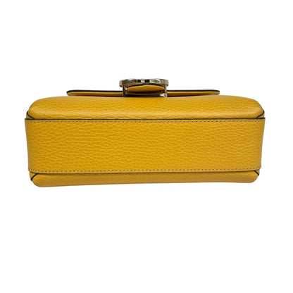 Gucci yellow leather crossbody bag with interlocking G logo and minor metal scratches.
