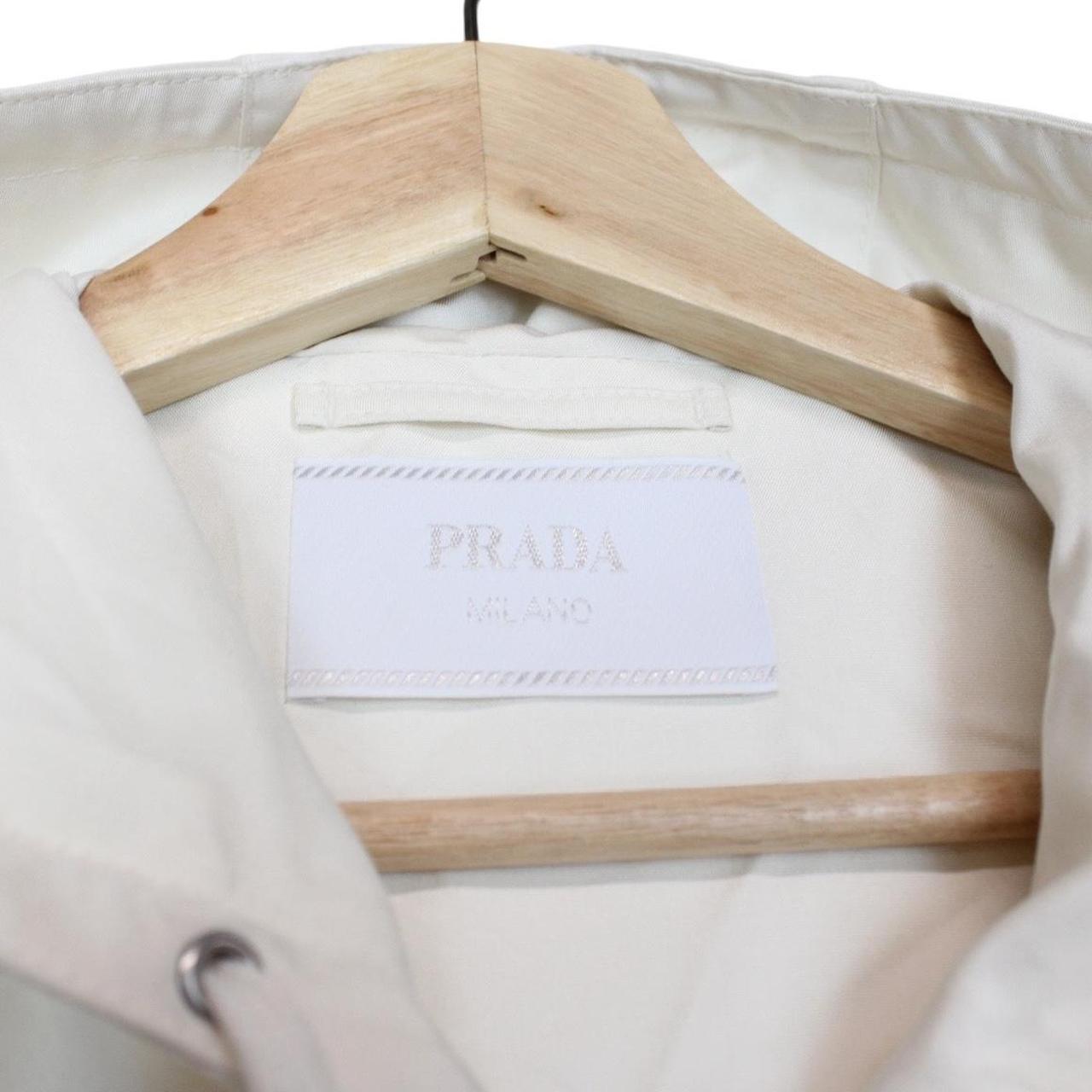 Prada cream silk hooded jacket with triangle logo and full zip detail.