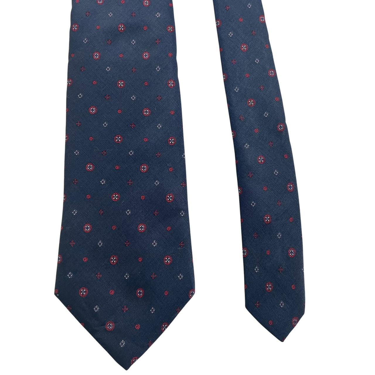 Yves Saint Laurent navy blue silk tie with subtle sheen and classic design.