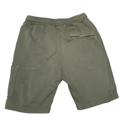 Stone Island green jogger shorts with logo patch and cotton material.