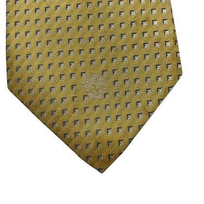Versace yellow silk tie with subtle pattern and faint mark on front.