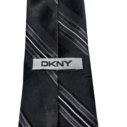 DKNY black silk tie with vintage striped pattern and logo detail.