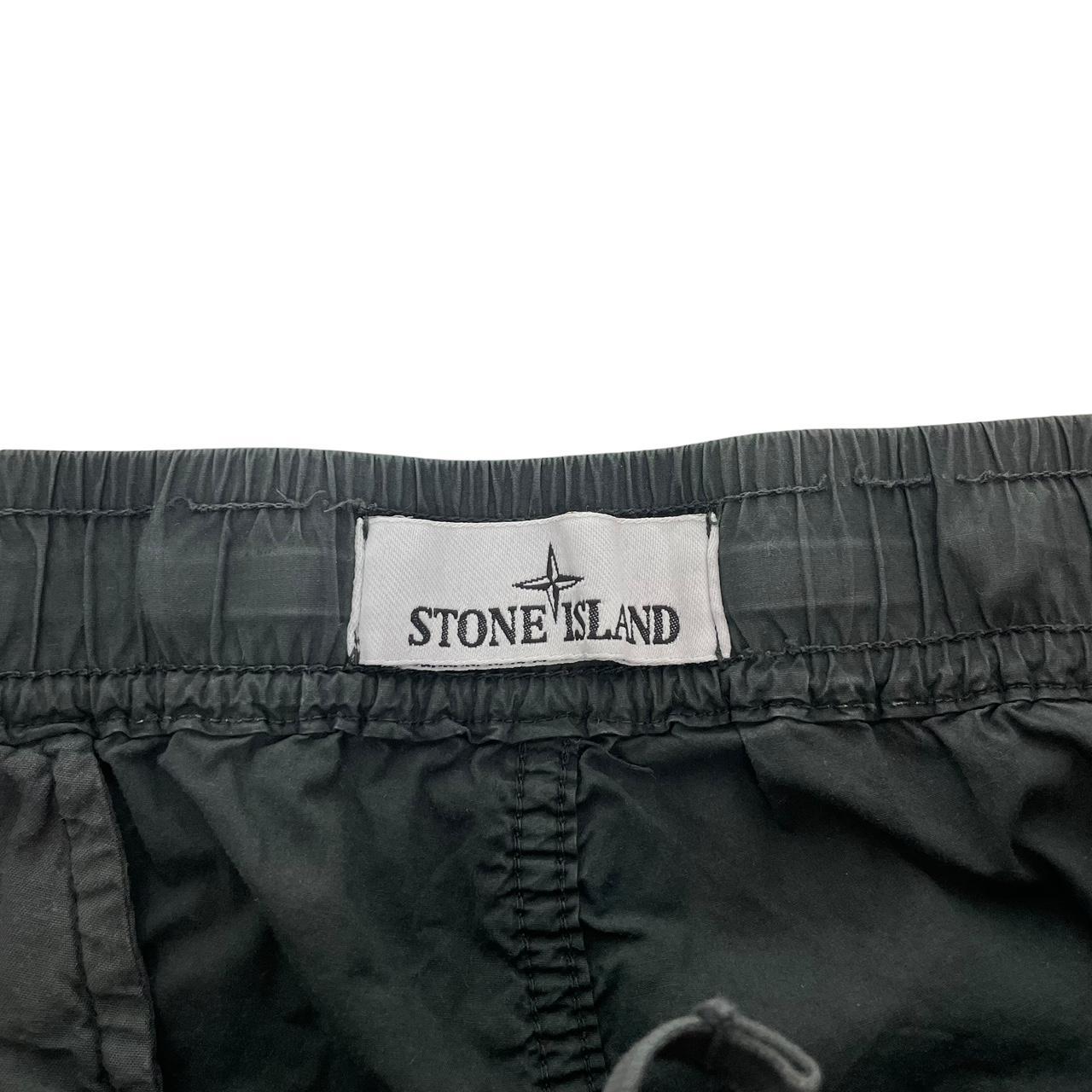 Stone Island grey cargo trousers with logo patch and loose stitch detail.