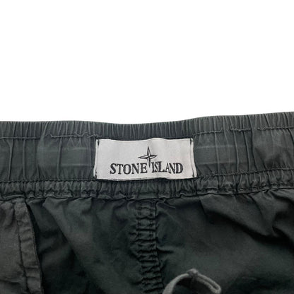 Stone Island grey cargo trousers with logo patch and loose stitch detail.