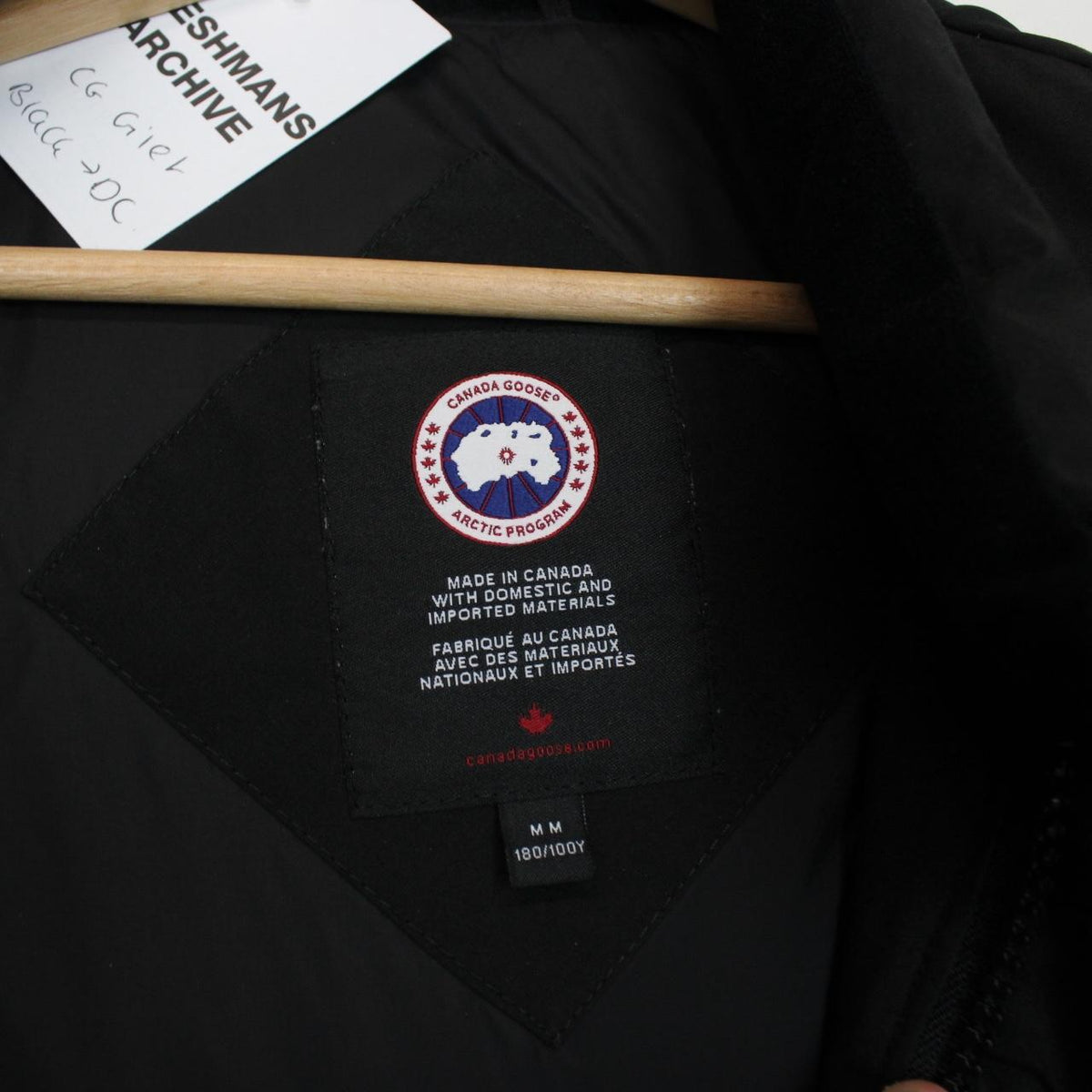 Canada Goose black down gilet with logo patch and zippered pockets.