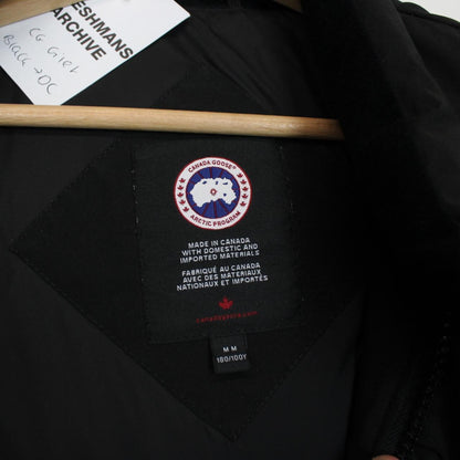 Canada Goose black down gilet with logo patch and zippered pockets.