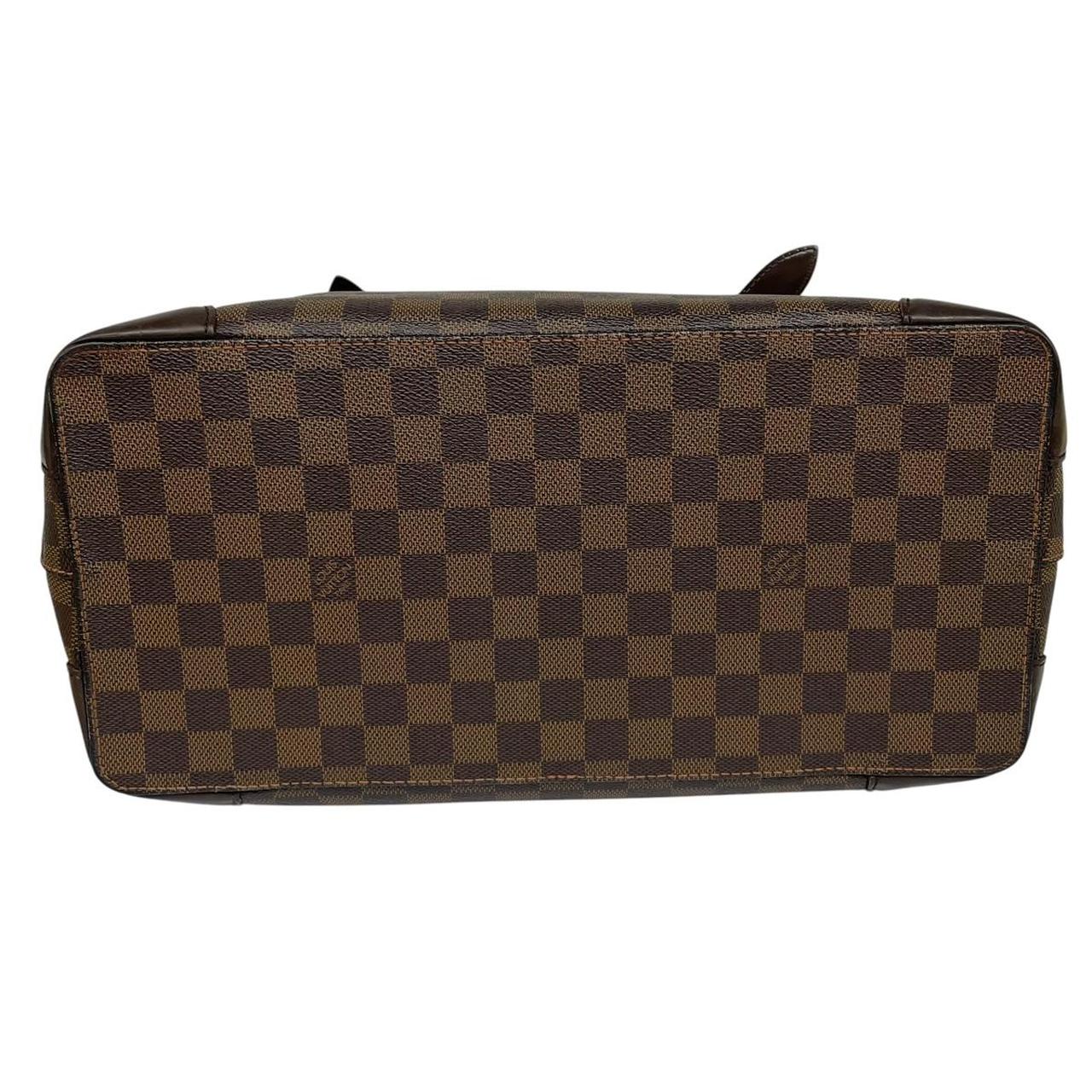 Louis Vuitton brown duffel bag with Damier Ebene pattern and logo plaque details.