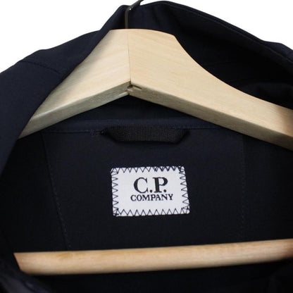 CP Company navy blue goggle jacket with full zip and soft shell material.